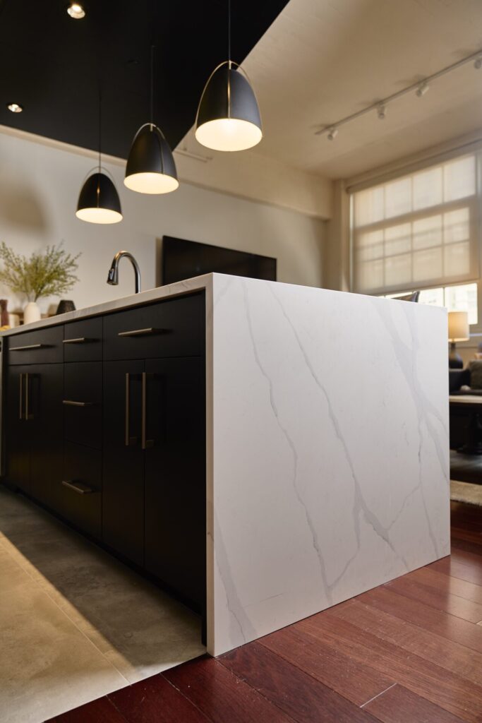 modern kitchen quartz island waterfall black cabinets corinth.jpg | The Design House