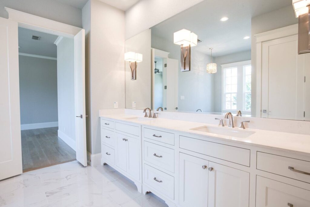 white bathroom heated tile floors vanity quartz plano remodel.jpg | The Design House